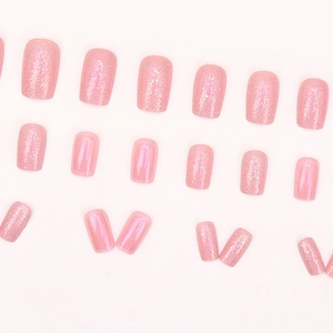 Sparkling Aurora pink press-on nails with fine glitter finish on white background
