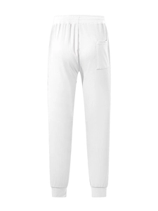 Detail of white waffle knit joggers featuring a back pocket and textured breathable fabric