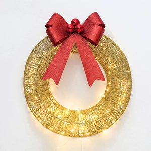 Detail of metal Christmas wreath with red glitter bow and warm LED lights on white background
