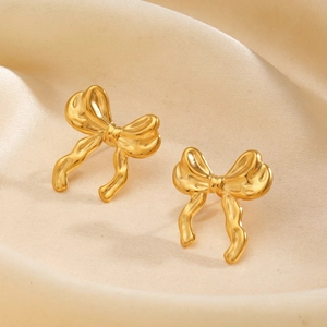 Elegant 18K gold plated bow earrings with hammered texture on champagne silk backdrop