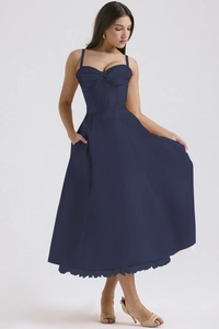 Detail of floral spaghetti strap maxi dress featuring practical side pockets and a cinched waist