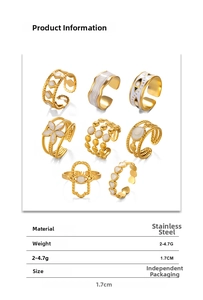 Collection of gold stainless steel rings with white enamel flower and eye designs