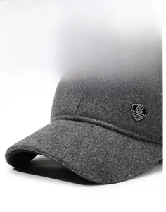 Detail of grey winter baseball cap showing sturdy brim and metallic shield logo badge