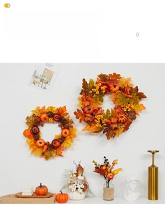 Detail of autumn wreath with maple leaves, berries and mini pumpkins for Halloween decoration