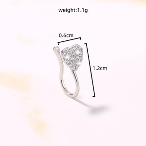 Detailed view of silver heart-shaped faux nose ring with inlaid diamonds and dimensions