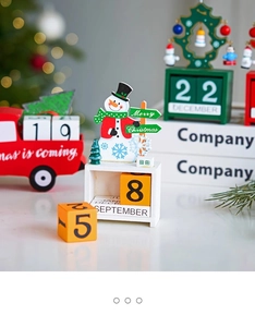Detail of wooden Christmas advent calendar with snowman, truck and festive blocks