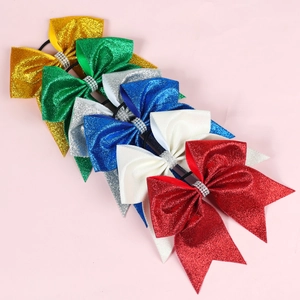 Detail of glitter bow hair ties with rhinestone center in gold green blue white and red