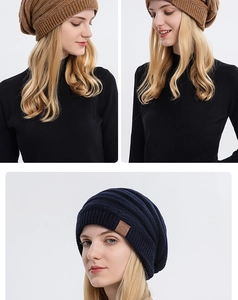 Detail view of thickened knit beanie with branded leather patch showing texture and fit