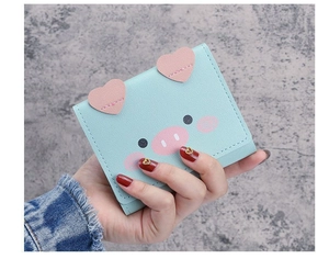 Detailed view of light blue leather mini wallet featuring a cute pink cartoon pig design