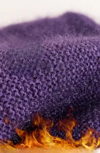 Detailed close-up of thick purple knit fabric texture highlighting thermal warmth