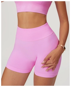 Detailed close-up of seamless pink purple yoga set featuring high waist shorts and sports bra