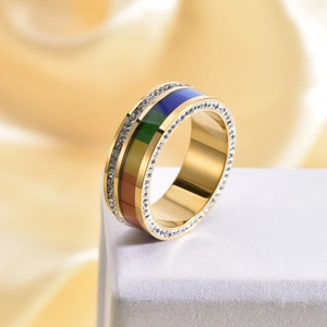 Detailed close-up of wide gold rainbow ring with double rows of pavé crystals