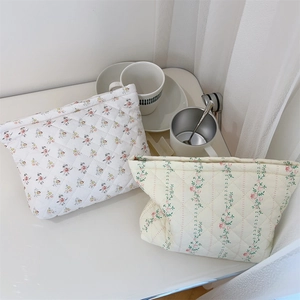 Quilted floral makeup bag detail showing thick padding and soft aesthetic patterns