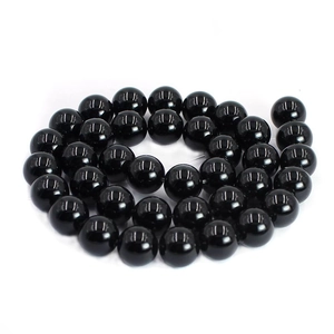 Detailed view of polished black agate round loose beads for DIY jewelry making
