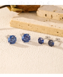 Detail showing two pairs of silver S925 earrings with sparkling blue rose-cut stones