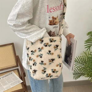 Detailed shot of a plush floral bucket bag with soft cream faux fur and vintage patterns