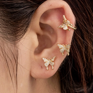 Golden butterfly ear clip set with micro-inlaid zircons worn on model's ear
