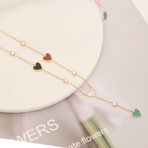 Gold stainless steel necklace with multi-colored heart pendants and zircon accents
