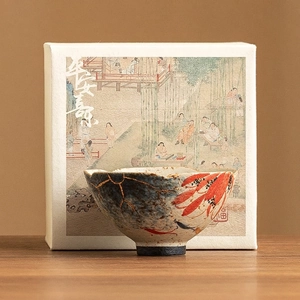 Ceramic tea cup with hand-painted koi fish and floral patterns in a luxury gift box