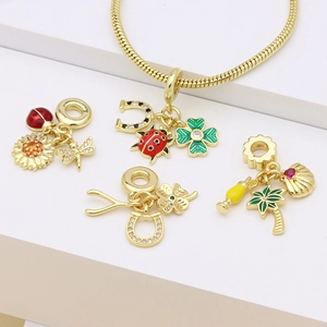 Golden enamel charms including ladybug and palm tree on a bracelet over a white background