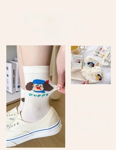 Close-up of cute cartoon puppy print on white cotton crew socks for women
