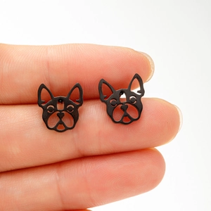 Close-up of matte black bulldog silhouette stud earrings made of stainless steel