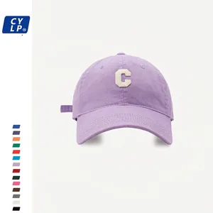 Detail of purple cotton baseball cap with white embroidered C letter and adjustable strap
