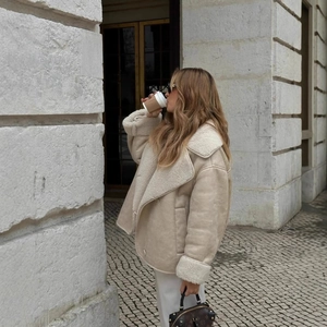 Women's beige faux suede shearling jacket with oversized collar in street style view