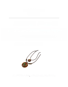 Detail view of ethnic long necklace with wooden pendant, metal bird relief, and leather cord