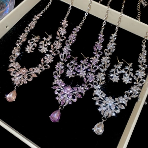 Detailed view of floral necklace and earring sets with sparkling teardrop rhinestones