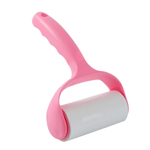 Pink handheld lint roller with ergonomic handle and white replaceable sticky paper roll