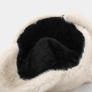 Detailed macro shot of the quilted inner lining and plush faux fur of the warm winter hat