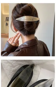 Detail of large acetate hair clip showing marbled texture and secure grip for women