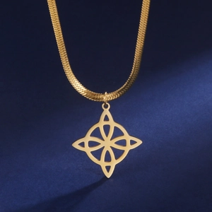 Close-up of golden stainless steel witch's knot pendant on a sleek flat snake chain necklace