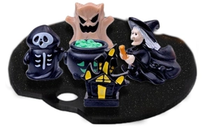 Detail of Halloween miniatures including ghost and skull on a black decorative base
