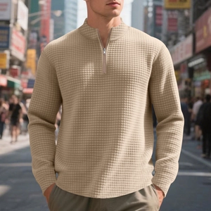 Detail showing the waffle textured fabric and half-zip stand collar of the khaki sweatshirt