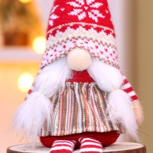 Christmas gnome doll with long legs and a red knitted snowflake hat for festive table decor