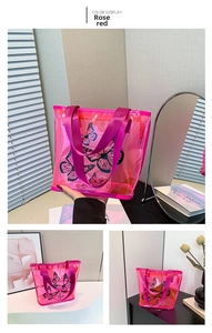 Detail of rose red transparent tote bag with black butterfly prints and nylon handles