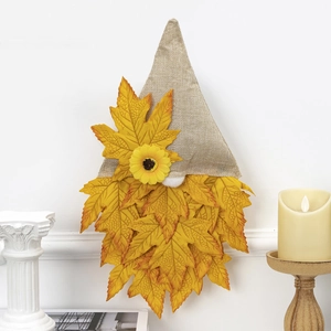 Detail of fall gnome wall decor with burlap hat, maple leaf beard, and sunflower accent