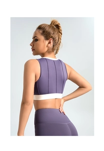 Detailed back view of purple sports bra with vertical ribs and white contrast trim