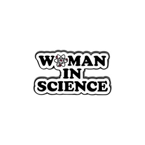 Woman In Science enamel pin featuring a cartoon atom symbol on a white background