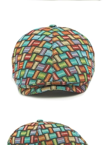 Detail of colorful geometric woven pattern on a retro cotton blend newsboy cap
