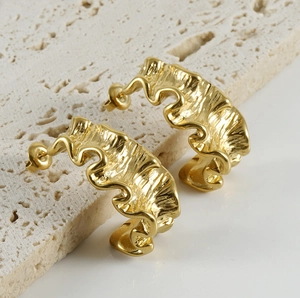 Macro shot of 18K gold plated stainless steel C-hoop earrings with lava crinkle texture