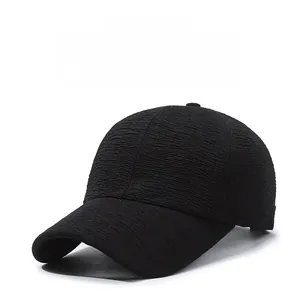 Close-up of black baseball cap showing detailed textured fabric and rippled knit pattern