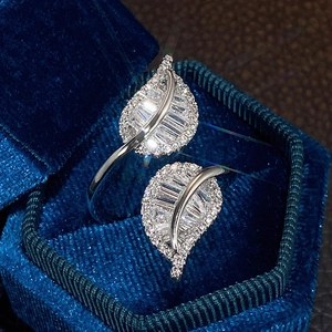 Macro shot of silver leaf-shaped ring with zircon inlays in a velvet jewelry box