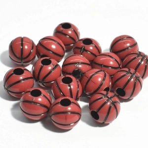 Macro shot of red and black acrylic basketball-shaped beads for jewelry making