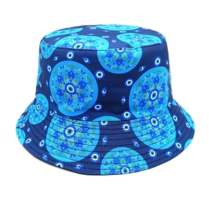 Detailed view of evil eye and blue mandala pattern print on navy fisherman hat