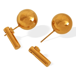 Minimalist gold ball stud earrings with detachable cylindrical pendants on white background