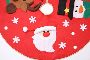 Close-up of red Christmas tree skirt featuring Santa, reindeer and snowman embroidery