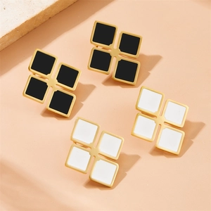 Minimalist gold clover earrings set with black and white enamel cubes for women